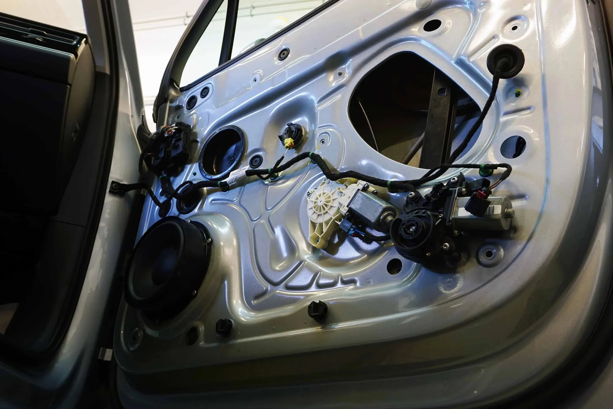 Window regulator assembly being replaced inside a car door in Las Vegas
